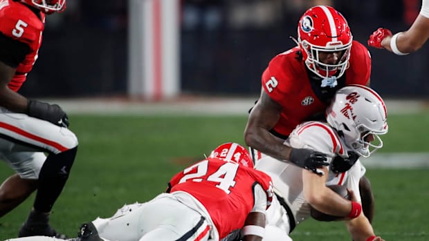 Ole Miss quarterback Jaxson Dart sacked by Georgia Bulldogs players at Samford Stadium in Athens, Ga. 